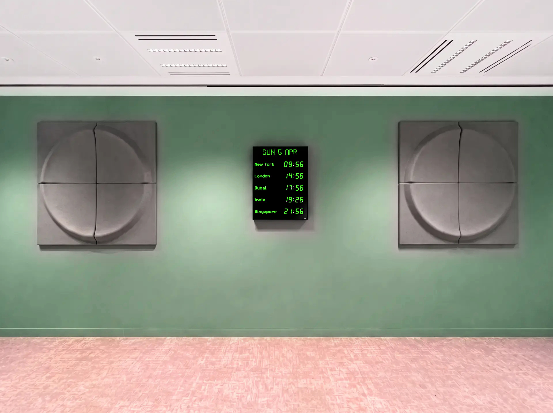 Five-zone vertical display with calendar in green on acoustic-panel wall